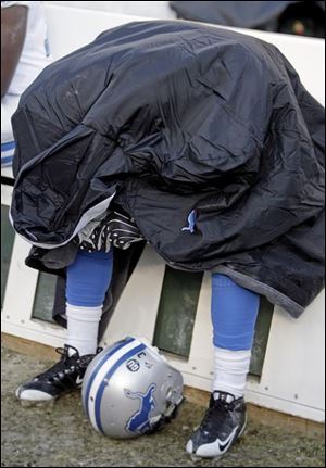 Lions running back Kevin Smith can't watch during the final seconds as Detroit loses to Green Bay to fall to 0-16. The rookie committed a costly taunting penalty on the Lions' final drive. 
