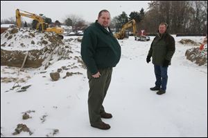 Matt Sutter, manager of development for LMHA, left, and the housing authority's Mike Field visit the site near Alexis Road and Lewis Avenue where the townhomes are being built.