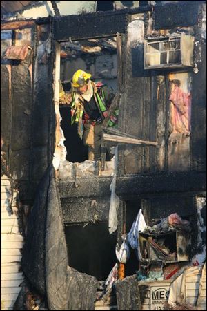 Slug: CTY bgfire05                       Date1/05/2009           The Blade/Amy E. Voigt                   Location: Bowling Green, Ohio  CAPTION: Members of the Bowling Green Fire Department work in an apartment after a fire broke out early Monday morning on December 5, 2008.