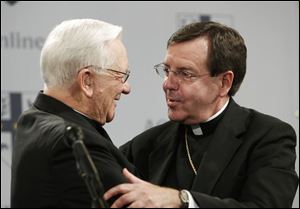 Associated Press Cardinal Adam Maida, left, congratulates his successor, Bishop Allen H. Vigneron, who was named archbishop of the Detroit diocese. The appointment was announced yesterday.