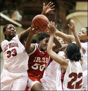 Central s Brianna Jones grabs a rebound while surrounded by Scott players. Jones had 17 points and 12 rebounds.