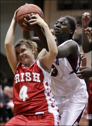 Central's Courtney Trenchik and Scott's Kendra Rison fight for a rebound last night. Central remained unbeaten in the City.