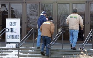Local members of the American Federation of State, County, and Municipal Employees enter Stranahan Theater to cast their votes for or against a new contract proposal.