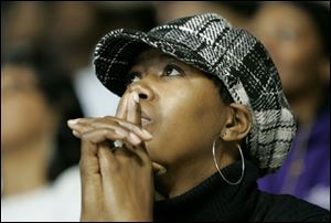 Bobbie Pam, a special education teacher at Rogers High School and a member of the YMCA's Youth Opportunity Program, listens to a speaker during the Martin Luther King, Jr., Unity Celebration at the University of Toledo's Savage Arena. 