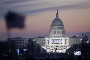 The sun rises on the U.S. Capitol and the already crowded National Mall on Inauguration Day as people continue to gather in anticipation of the swearing-in of President-elect Barack Obama on Tuesday, Jan. 20, 2009 in Washington. 
