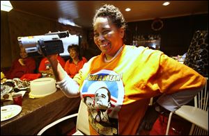 Avie Dixon, an African-American studies teacher retired from Scott High School, beams watching the inauguration.