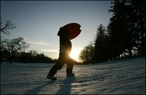 Slug: ROV sled22p Date:  01212009        The Blade/Andy Morrison       Location:  Toledo       Caption: Jocelyn Shook, 6, Toledo, makes another tip up the sledding hill as she and her family enjoy the late afternoon sun sledding at Ottawa Park, Wednesday, 01212009. Summary: