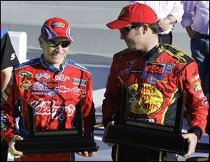 Daytona 500 pole-winner Martin Truex, Jr., right, and Mark Martin, who qualified second, enjoy their hardware they won for locking up positions on the grid for Sunday's race.