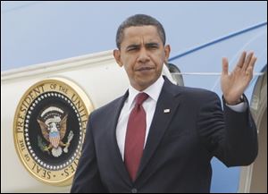 President Obama waves upon his arrival in South Bend, Ind., on Monday en route to a town hall style meeting about the economy in Elkhart, Ind. 