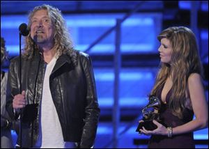 Robert Plant and Alison Krauss accept one of their five Grammys of the night.