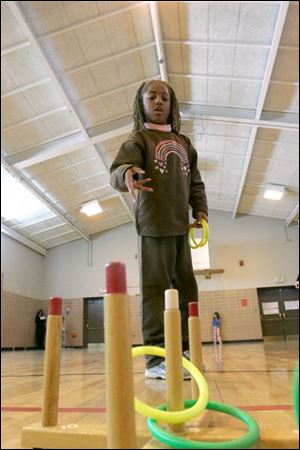Taylor Baldwin, 7, tries for 100 points during the hoop toss.
