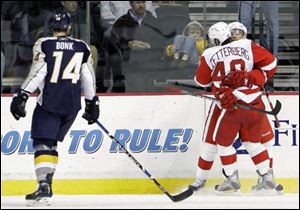 Red Wings center Henrik Zetterberg (40) is congratulated by Pavel Datsyuk after Zetterberg scored a goal against the Predators in the third period Tuesday night Nashville.