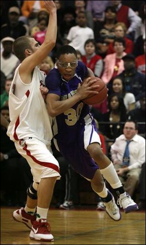 Waite s Darius Glover drives with determination past Irish defender Steve Becker.