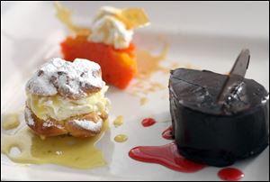 Clockwise from left: A dessert plate with a key lime mascarpone cream puff, slice of peach poundcake, and a slice of chocolate bourbon cake will be served at the chefs  dinner.