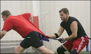 Dan Nowak, right, tries to pull the flag off an opponent during the football game at the center.