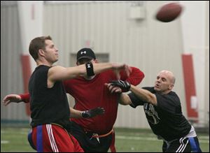 Dan Nowak, left, gets a pass off during a game at Sylvania Sport and Exhibition Center.