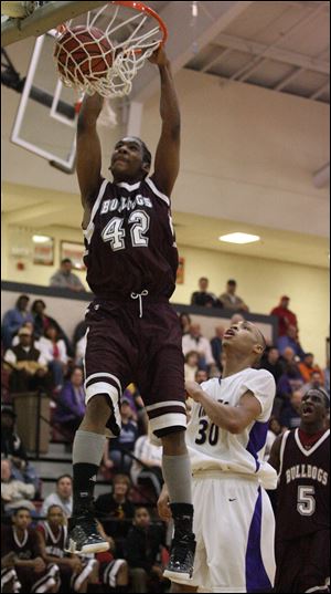 Scott s Owen Dotson slams down two points in the Bulldogs  upset victory over Waite at Central Catholic. Dotson finished with 15 rebounds. Scott will play Rogers on Thursday.