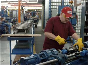 Chad Holmes works on a drive shaft at Dana Holding Corp. s parts plant in Lima, Ohio, last year. The firm has not met revenue or profit projections since emerging from bankruptcy last year.