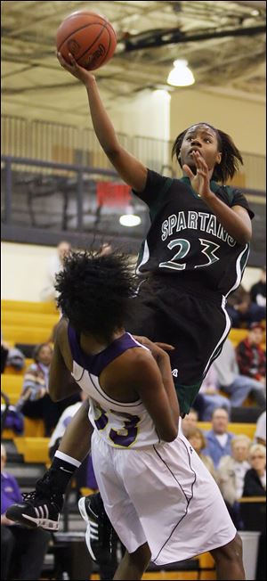 Start freshman Jaymie Jackson drives to the basket against Waite's Natasha Howard. Jackson scored 16 points as the Spartans advanced to Tuesday's regionals. 