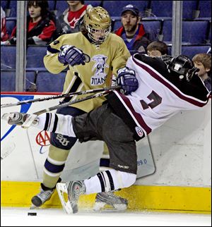 St. John's Kyle Knox, left, and Tommy Goetz of University School collide near the boards yesterday during the state hockey final at Nationwide Arena in Columbus. The Titans finished 27-9-3.