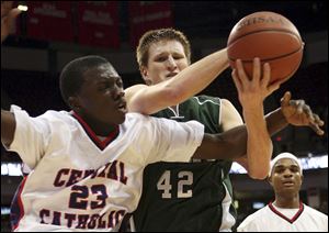 Cleveland Central Catholic s Brandon Campbell, left, battles Tinora s Jon Gerken for the ball in
Saturday's Division III state championship game in Columbus. The Rams finished 23-4.