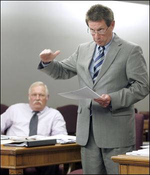 Sgt. Terry Stewart, left, chief of the Toledo Police Command Officers Association, listens to union attorney Gregory Lodge.