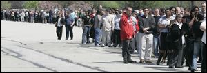 Thousands of people waited in a line that stretched a quarter mile or more to attend the job fair held Friday in Maumee.