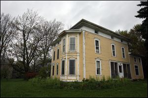 Interior features include hardwood floors, original woodwork, a maple staircase, and a marble fireplace.