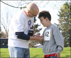 Scott Young congratulates his daughter Schyler after she finishes the race. About 230 people participated in the event.