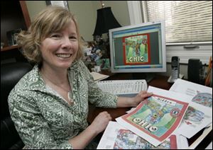 Julie Rubini looks at copies of the preliminary spreads of her new book,  Hidden Ohio,  at her home in Maumee.