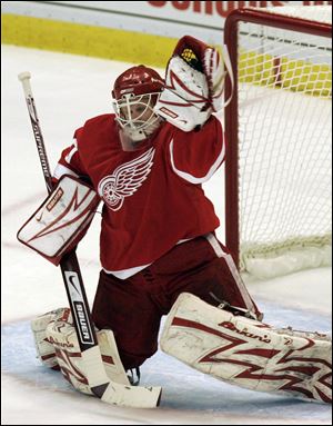 Red Wings goaltender Chris Osgood stops a shot in
Sunday's game against Anaheim. He had 16 saves.