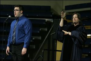CTY utgrad10p  Bowsher High School graduate and Universityof Toledo music major Sam Mason, left, sings the Star-Spangled Banner and Terri (cq) Stibaner inteprets it.  Graduation ceremonies are held at the University of Toledo in Toledo, Ohio on May, 10, 2009. There are 2,944 candidates for degrees from the colleges of Arts and Sciences, Business Administration, Education, Engineering, Health Science and Human Service, Law, Medicine, Nursing, Pharmacy and University College.   The Blade/Jetta Fraser