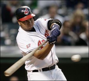 Shortstop Jhonny Peralta hits a two-run single in the fourth
inning Monday night. The Indians broke a team slump with 13 hits.