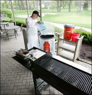 Chef Greg Curtland prepares steaks at Stone Oak, which, like other clubs, has lost some members because of the poor economy.