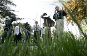 Toledo Mayor Carty Finkbeiner announces a plan to get the grass cut in Toledo city parks and cemeteries during a news conference in River Road Park in South Toledo on Friday.
