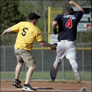 Tom Birie, left, of the Fricker s Yellow Team, tries to tag Greg Phaflar of Allshred.