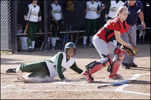 Clay junior Eryn Simon, hitting .429 (4 HR, 34 RBIs) scores as Central Catholic catcher Rachael Ryan awaits the throw in the City League final.