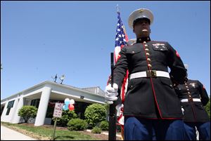 Lance Cpl. Richard Cable and other members of the Marine Corps stand in front of the Vet Center, 1565 S. Byrne Rd., Ste. 104, Toledo. The center, which opened in August, had an open house yesterday. It offers readjustment counseling and outreach services to any veteran who served in any combat zone. It also offers help to family members.