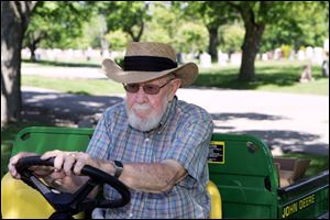 World War II veteran Don Horton, 82, drives the cart of flags. 'I do this   to remember the guys who went before me.'