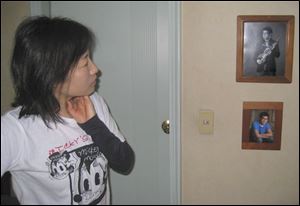 Young Jung gazes at pictures of Andrew in the couple s
apartment near Seoul. The Jungs use a computer to stay
in touch with their son, a high school senior in Toledo.