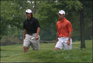 Oklahoma State's Ricky Fowler, left, and Florida's Billy Horschel walk to the green on No. 14 at
Inverness yesterday. Horschel's 76 was the team's top score as the No. 3 Gators struggled.
