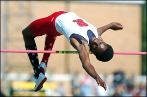 Erik Kynard of Rogers clears the bar at 6 feet, 7 inches to advance
to the state meet. An injury kept him from going higher.