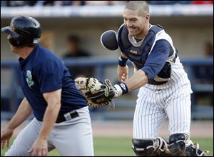 Mud Hens catcher Dusty Ryan runs down Charlotte's Brian Myrow in the second inning Saturday night at Fifth Third Field.