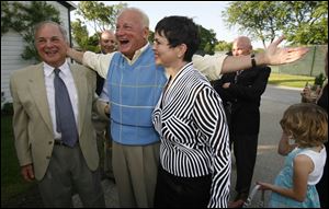 Slug: SOC surprise01p E     The Blade/Jeremy Wadsworth  Date: 05/30/09  Caption: Carty Finkbeiner greets his brother David Finkbeiner as his wife Amy Finkbeiner looks on during his surprise birthday party Saturday, 05/30/09, at the Carranor Hunt and Polo Club in Perrysburg, Ohio.