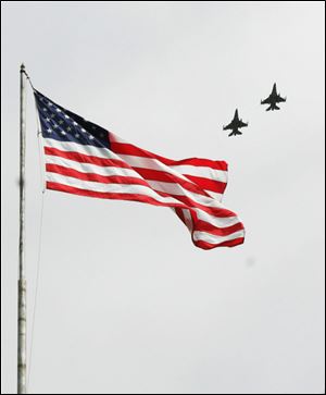 CTY memorial31p         05/30/2009     The Blade/Lori King  The 180th Fighter Wing performs a fly-over during the dedication of the Korean War monument at Clay High School's Memorial Stadium in Oregon, OH.