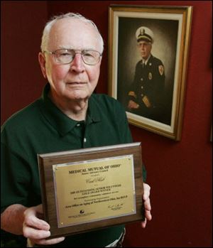 Carl Neeb displays the award that he won because of the work he has done to improve the safety of the elderly.