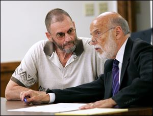 Thomas Zich talks with his attorney, Alan Konop, before jury selection for his trial in Lucas County Common Pleas Court.