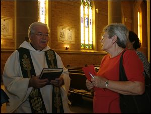 CTY Kwiatkowski29p  40-year parishioner Maria Carmen Fragoso, right, with an autographed copy a musical work [in left hand]by Fr. Paul Kwiatkowski, left. Father Paul Kwiatkowski of Immaculate Conception Parish, Toledo, retires, saying his last Mass in that position on Sunday, June 28, 2009.  The Blade/Jetta Fraser