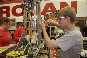 NBRN robot01p  The Blade/Lisa Dutton 06_27_09 Monroe,MI Chris Sommers,soph from team Bedford Express works on the advanced robot during the competition. An advanced robotics team competition will be held at Monroe High School in Monroe,MI.,  on friday and Saturday. High school teams from as far away as Wisconsin and Indianapolis will attend.