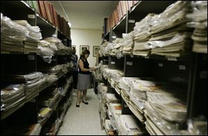 Archivist Dianna Denny looks through past editions of the Saturday Evening Post at the magazine's offices in Indianapolis.